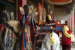 Colorful traditional Tibetan ceremony with monks and spiritual leaders in ornate attire.