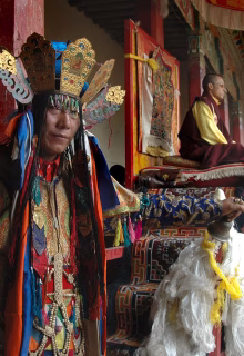 Colorful traditional Tibetan ceremony with monks and spiritual leaders in ornate attire.