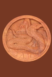 Clay sculpture of a snake intertwined with a dragon, detailed art piece.